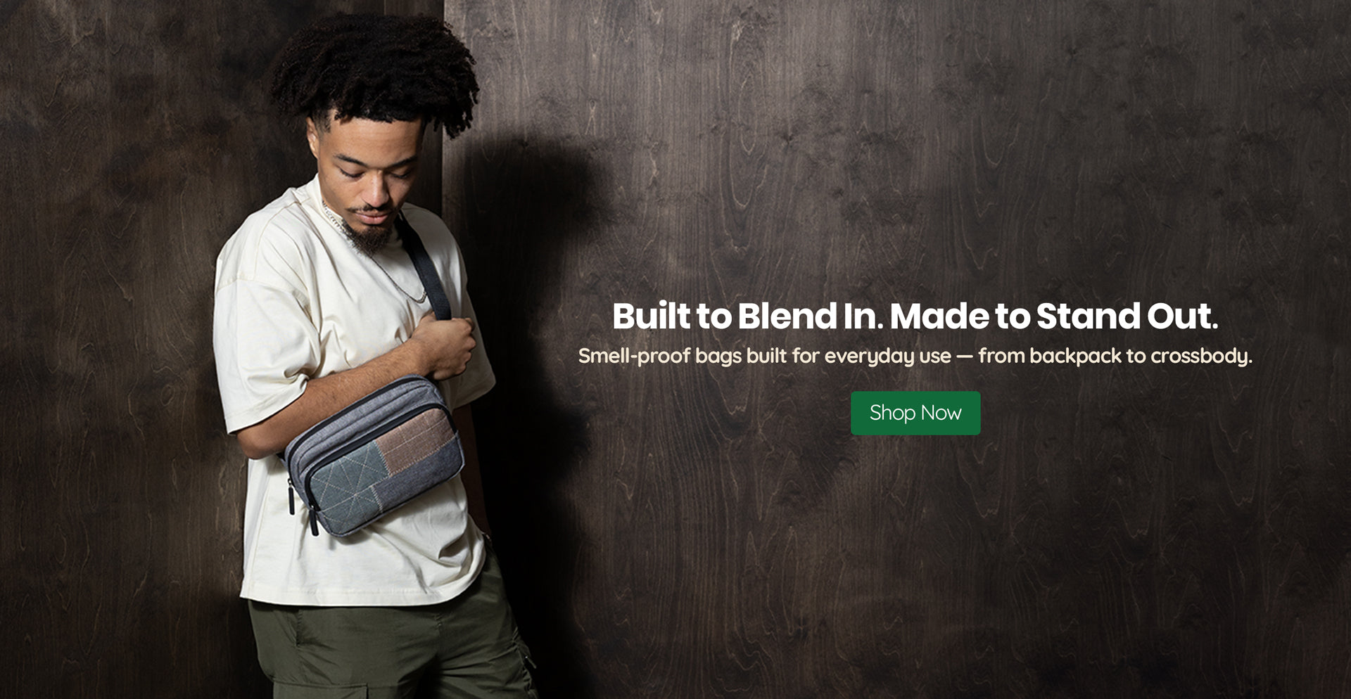 Man standing against wood wall, text reads Built to blend in. Made to stand out.